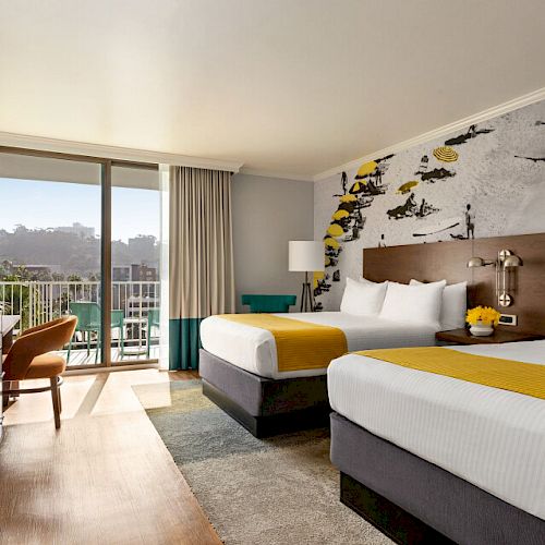A modern hotel room with two double beds, a TV, a desk, large windows, and a balcony with a scenic view, featuring surf-themed wall art.