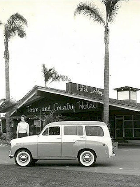 A vintage photo shows a person and classic car in front of the Town and Country Hotel, surrounded by palm trees.